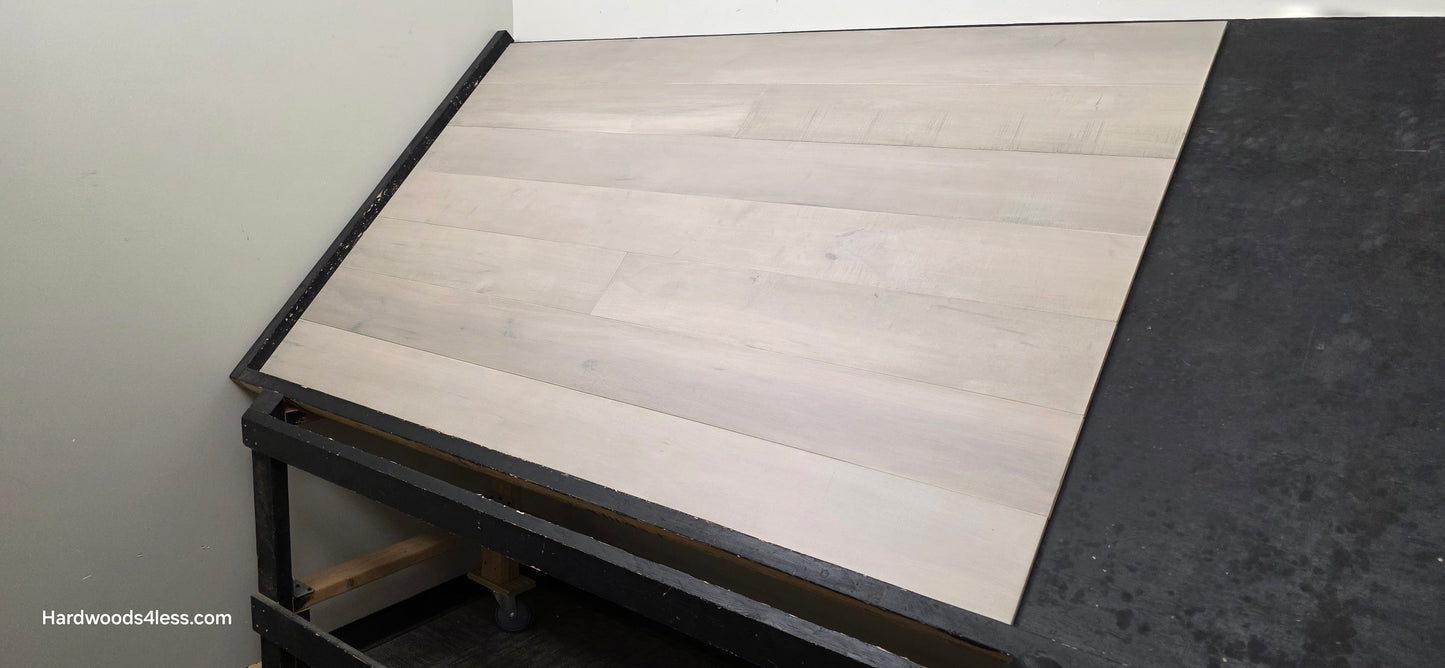 6 1/2" x 1/2" Engineered Maple Misty Moonlight Hardwood Flooring shown on a black shooting table.