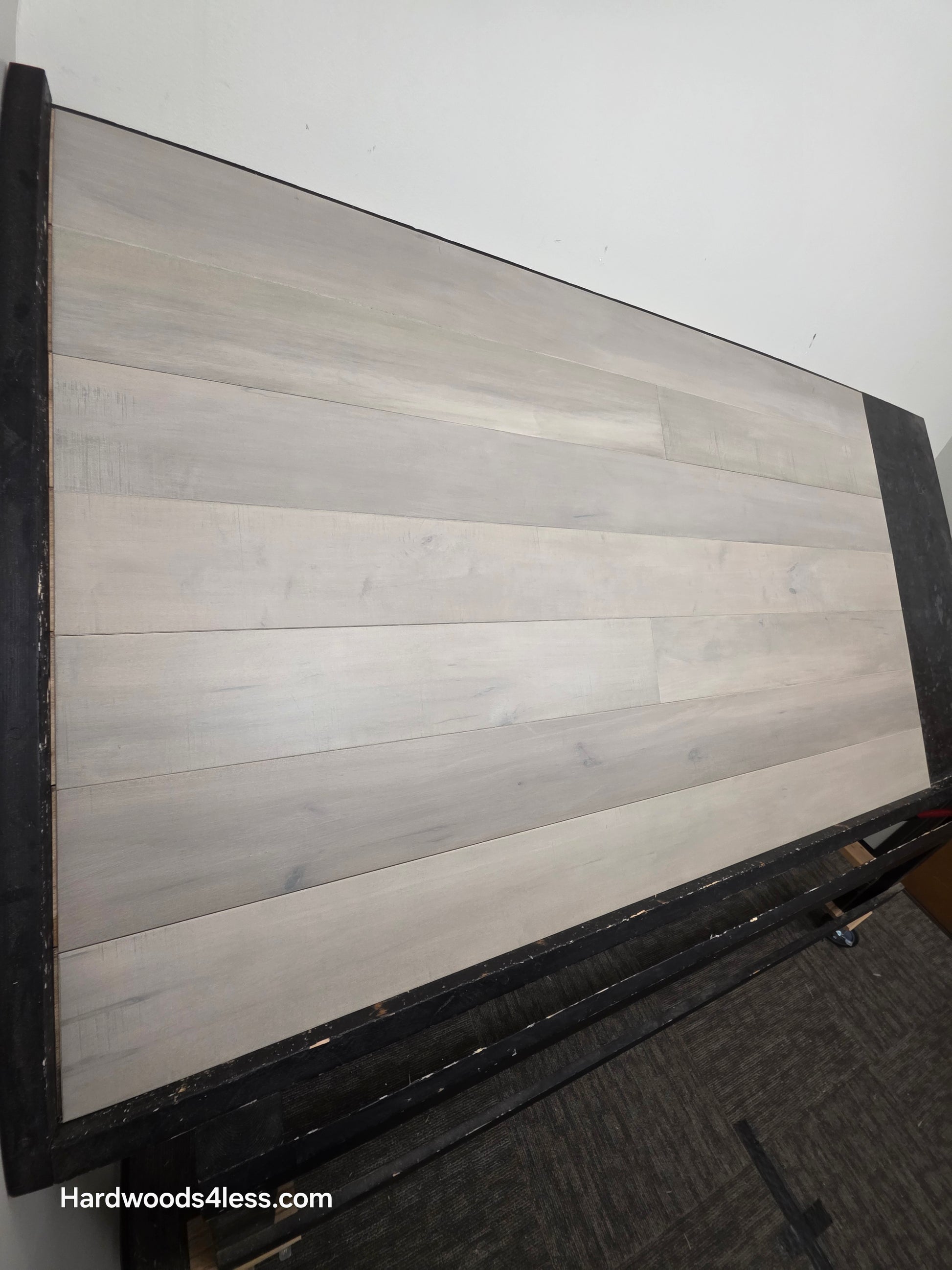 6 1/2" x 1/2" Engineered Maple Misty Moonlight Hardwood Flooring shown on a black shooting table.