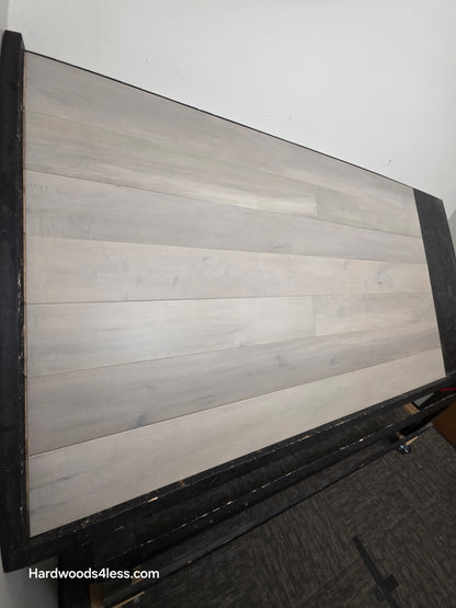 6 1/2" x 1/2" Engineered Maple Misty Moonlight Hardwood Flooring shown on a black shooting table.