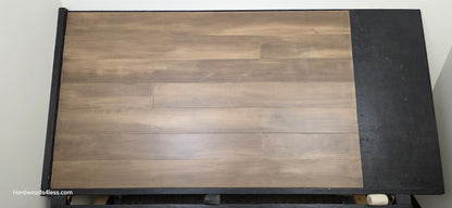 6 1/2" x 1/2" Engineered Maple Peat Hardwood Flooring. Shown on a black shooting table. Shot from center.