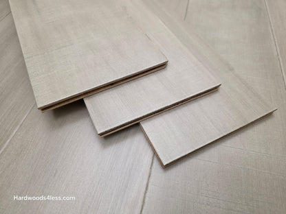 6 1/2" x 1/2" Engineered Maple Polar Palace Hardwood Flooring shown with three boards stacked on top of the flooring.
