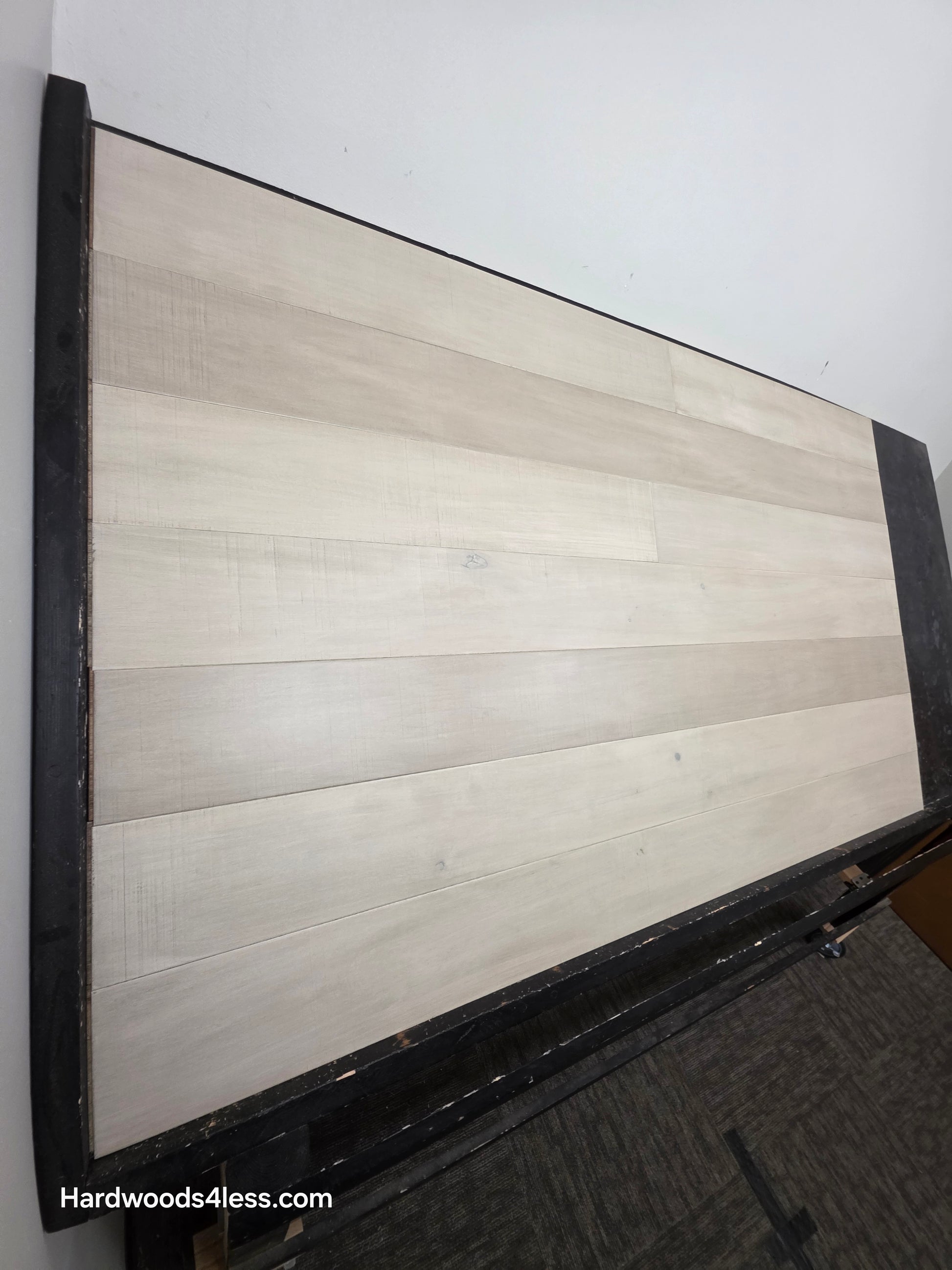 6 1/2" x 1/2" Engineered Maple Satin Sunrise Hardwood Flooring. Shown on a black shooting table left hand shot