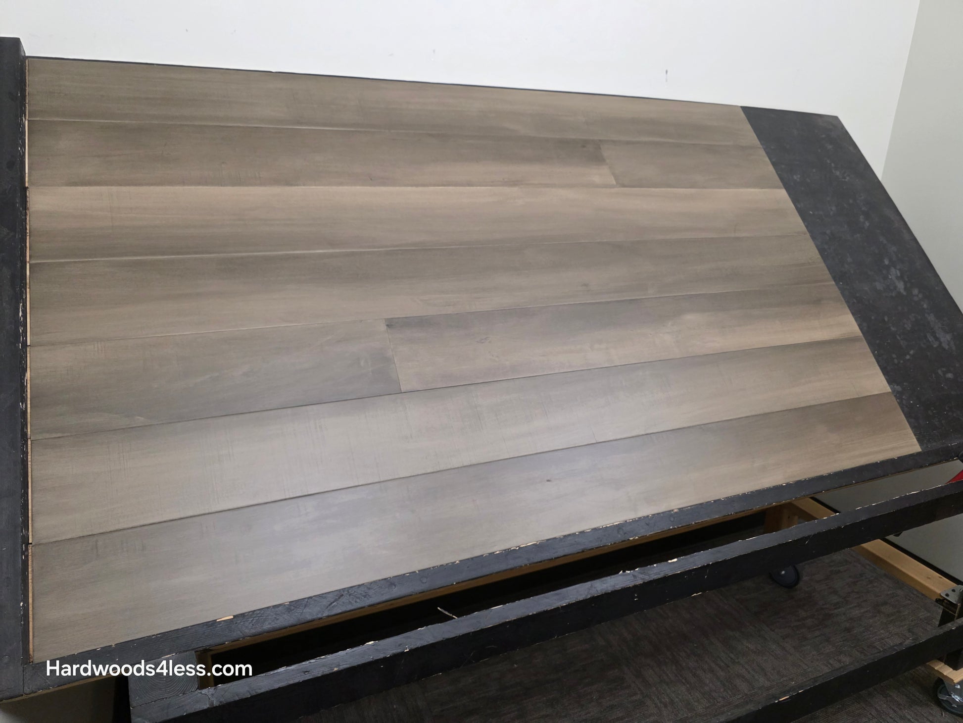 6 1/2" x 1/2" Engineered Maple Weathered Winter Hardwood Flooring. Shown on a black shooting table.
