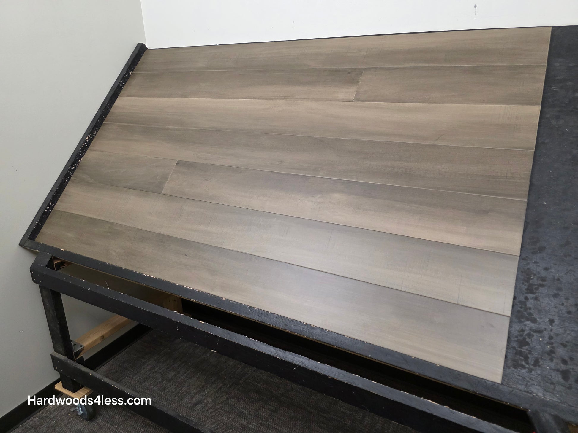 6 1/2" x 1/2" Engineered Maple Weathered Winter Hardwood Flooring. Shown on a black shooting table 