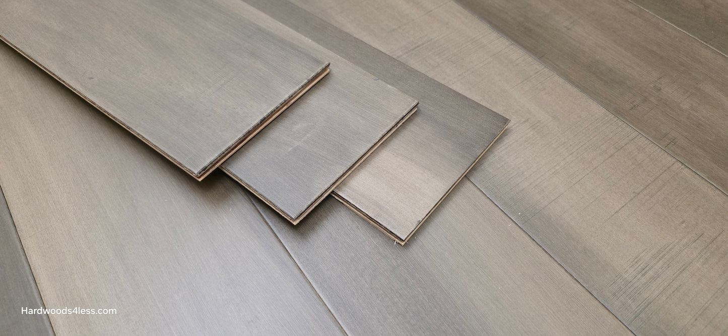6 1/2" x 1/2" Engineered Maple Weathered Winter Hardwood Flooring. Shown with three extra boards stacked in the center of the frame.