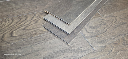 6 1/2" x 3/8" Engineered White Oak Nocturne Hardwood Flooring. Shown at center is 3 planks of the flooring. They planks are on top of the White Oak flooring.