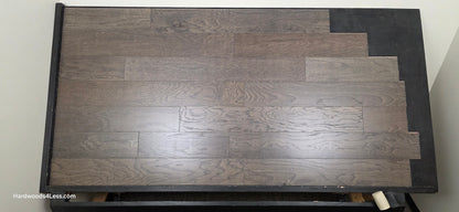 6 1/2" x 3/8" Engineered White Oak Nocturne Hardwood Flooring. Shown on a black shooting table. Shot from center.