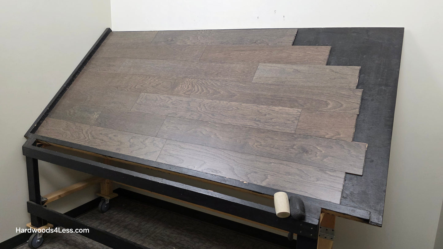 6 1/2" x 3/8" Engineered White Oak Nocturne Hardwood Flooring. Shown on a black shooting table. Shot from wide right.