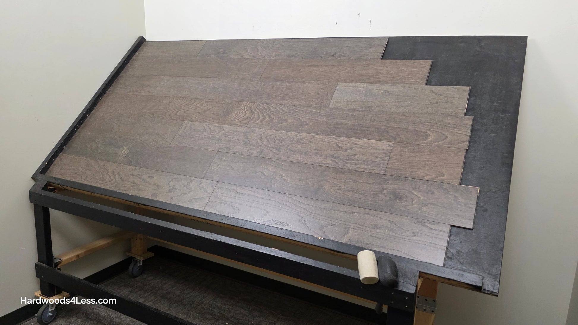 6 1/2" x 3/8" Engineered White Oak Nocturne Hardwood Flooring. Shown on a black shooting table. Shot from wide right.