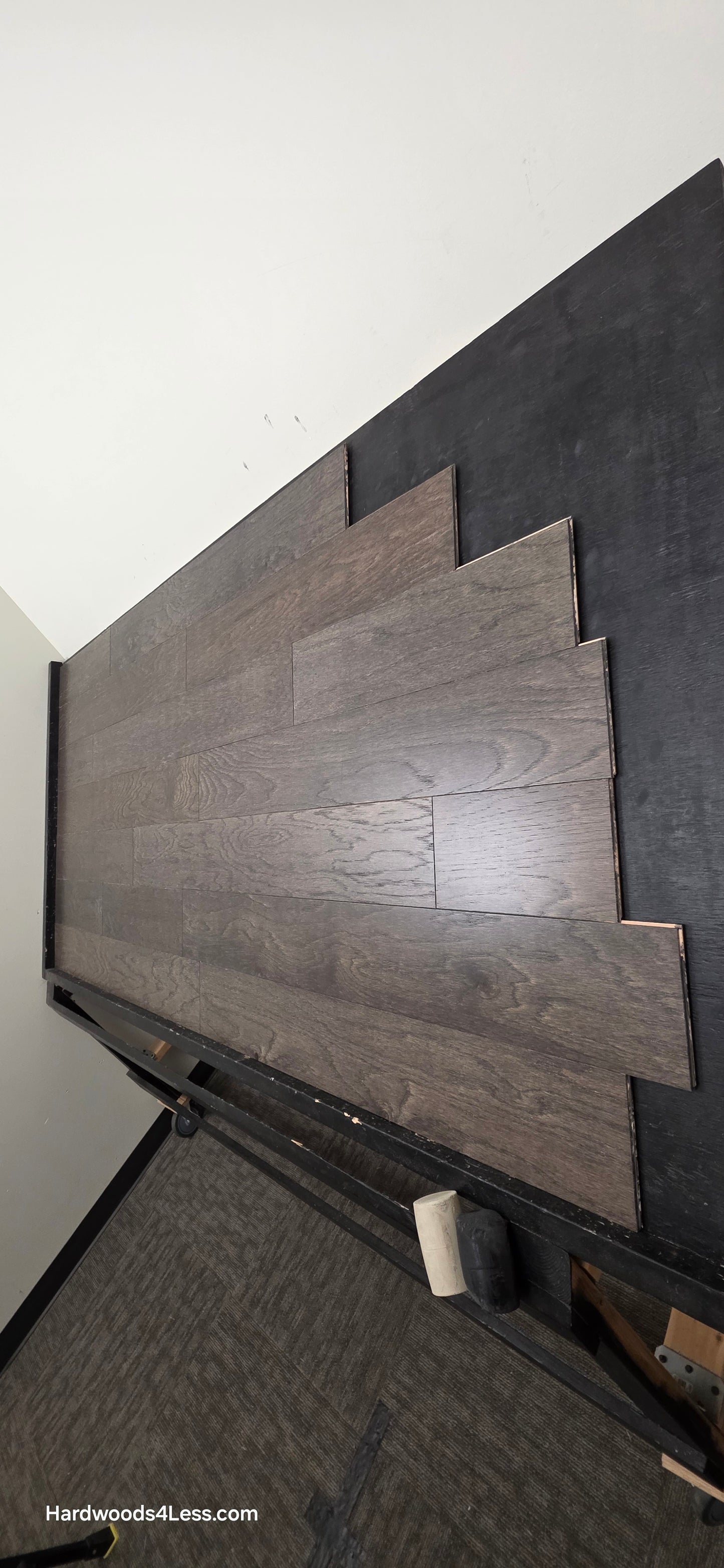 6 1/2" x 3/8" Engineered White Oak Nocturne Hardwood Flooring. Shown on a black shooting table. Shot from steep right.