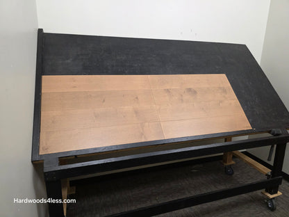 6 1/2" x 5/8" Engineered Maple Sandy Beach Hardwood Flooring. Shown on a black shooting table. Shot from wide left.