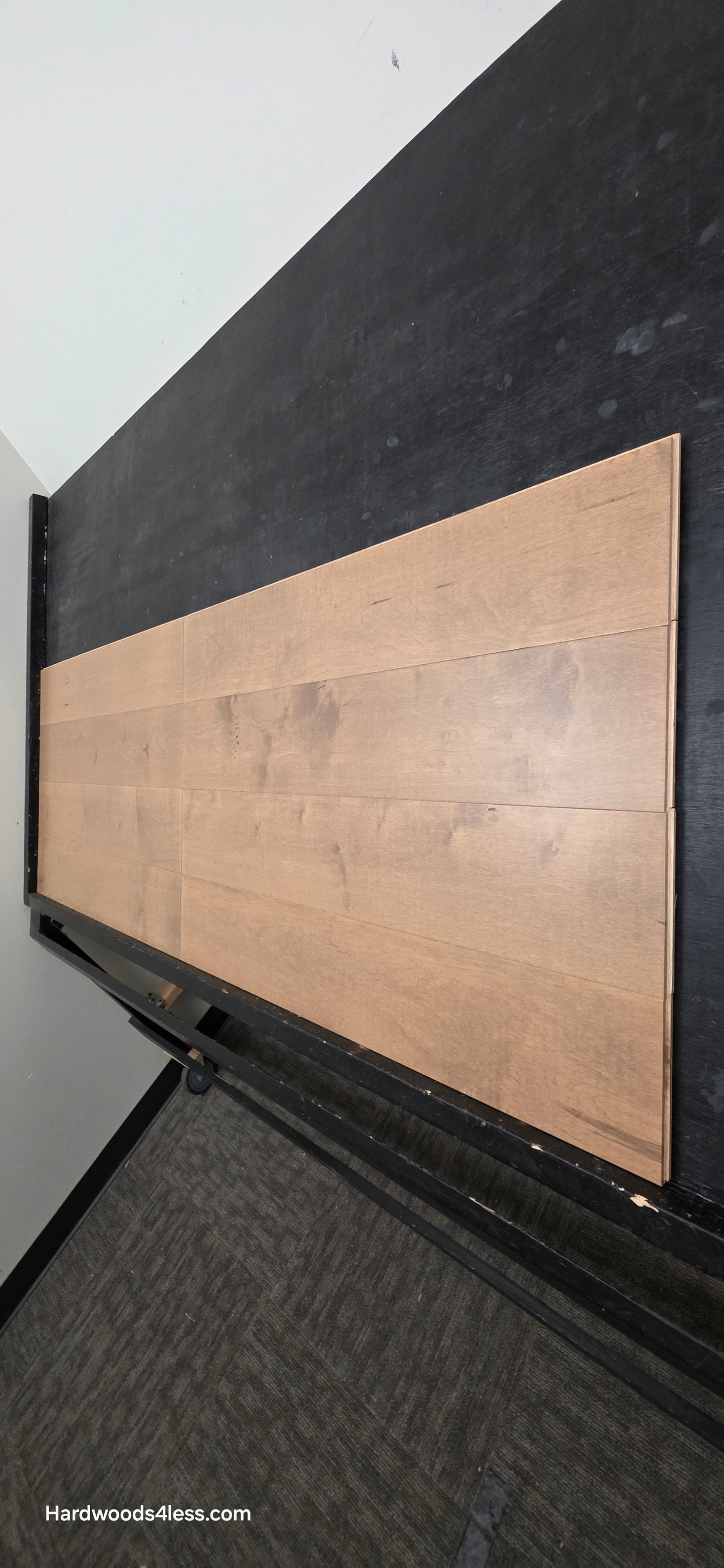 6 1/2" x 5/8" Engineered Maple Sandy Beach Hardwood Flooring. Shown on a black shooting table. Shot from steep right.