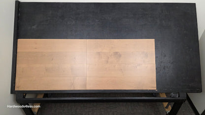 6 1/2" x 5/8" Engineered Maple Sandy Beach Hardwood Flooring. Shown on a black shooting table. Shot from center.