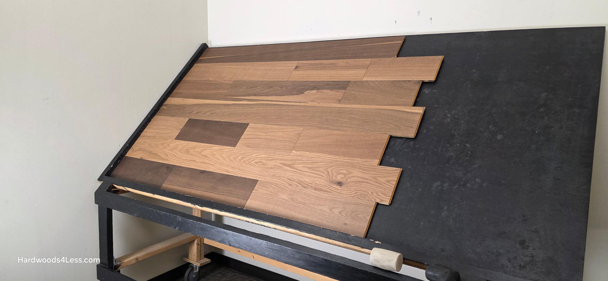 6 1/2" x 7/16" Engineered White Oak Wingham Hardwood Flooring. Shown on a black shooting table. Shot from wide right.