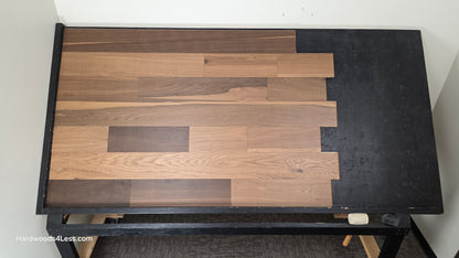 6 1/2" x 7/16" Engineered White Oak Wingham Hardwood Flooring. Shown on a black shooting table. Shot from center.