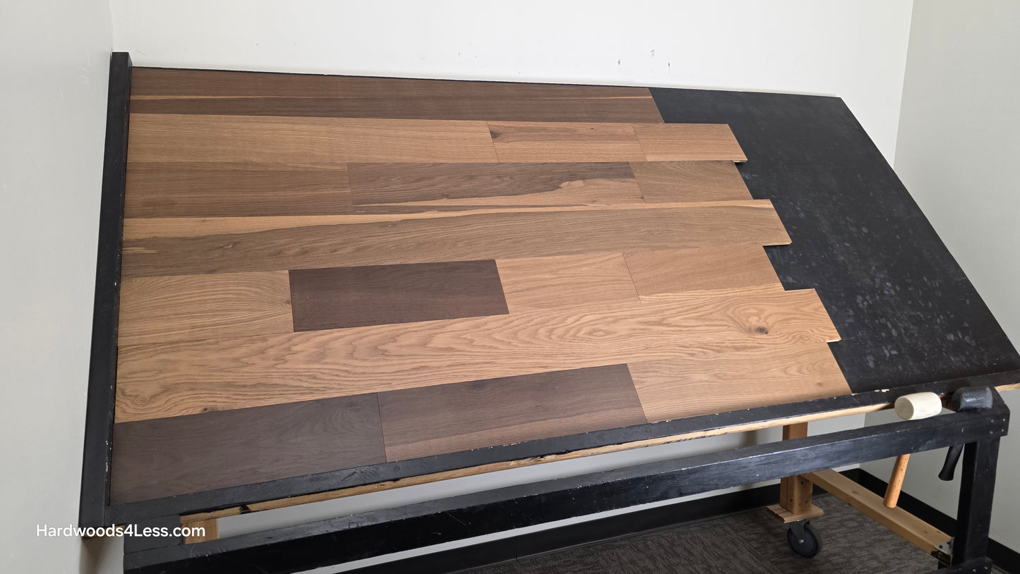 6 1/2" x 7/16" Engineered White Oak Wingham Hardwood Flooring. Shown on a black shooting table. Shot from wide left.