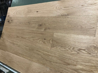 6" x 3/4" Unfinished White Oak #1 Common Solid Hardwood Flooring on a green shooting rack.