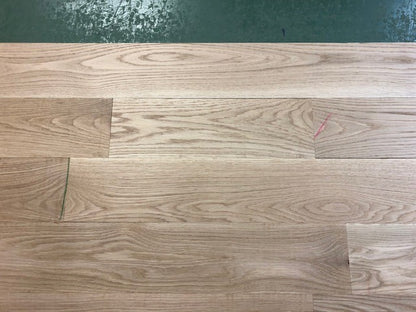 6" x 3/4" Unfinished White Oak Select & Better Solid Hardwood Flooring shown on a green shooting table 