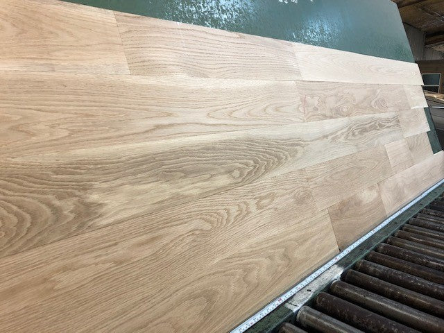 6" x 3/4" Unfinished White Oak Select & Better Solid Hardwood Flooring shown on a green shooting table 