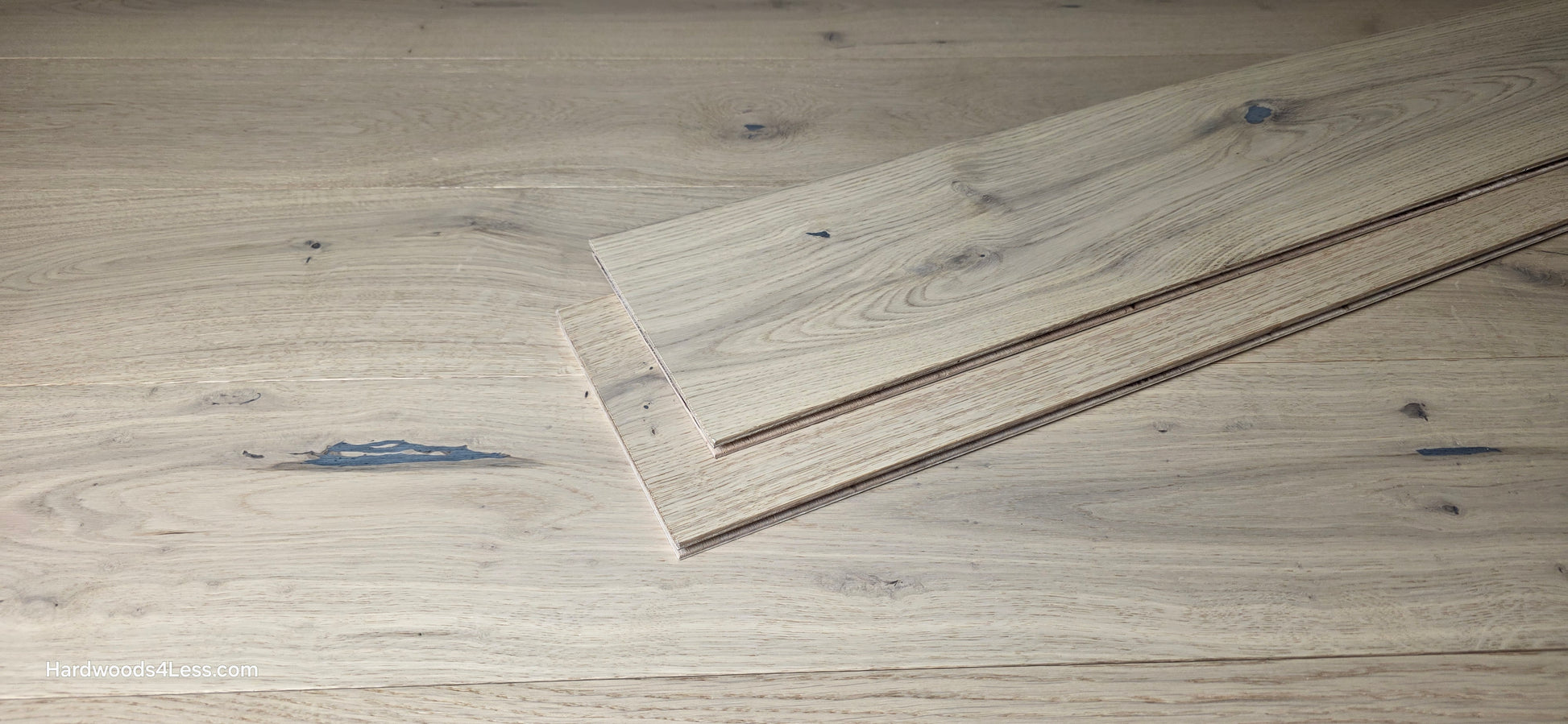 7 1/2" x 1/2" Engineered European White Oak Belleray Hardwood Flooring. Shown as 2 planks stacked on top of each other in the center of the Engineered flooring. 