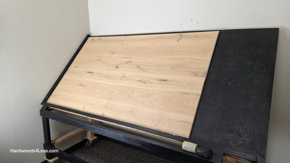 7 1/2" x 1/2" Engineered European White Oak Belleray Hardwood Flooring. Shown on a black shooting table. Shot from wide right.