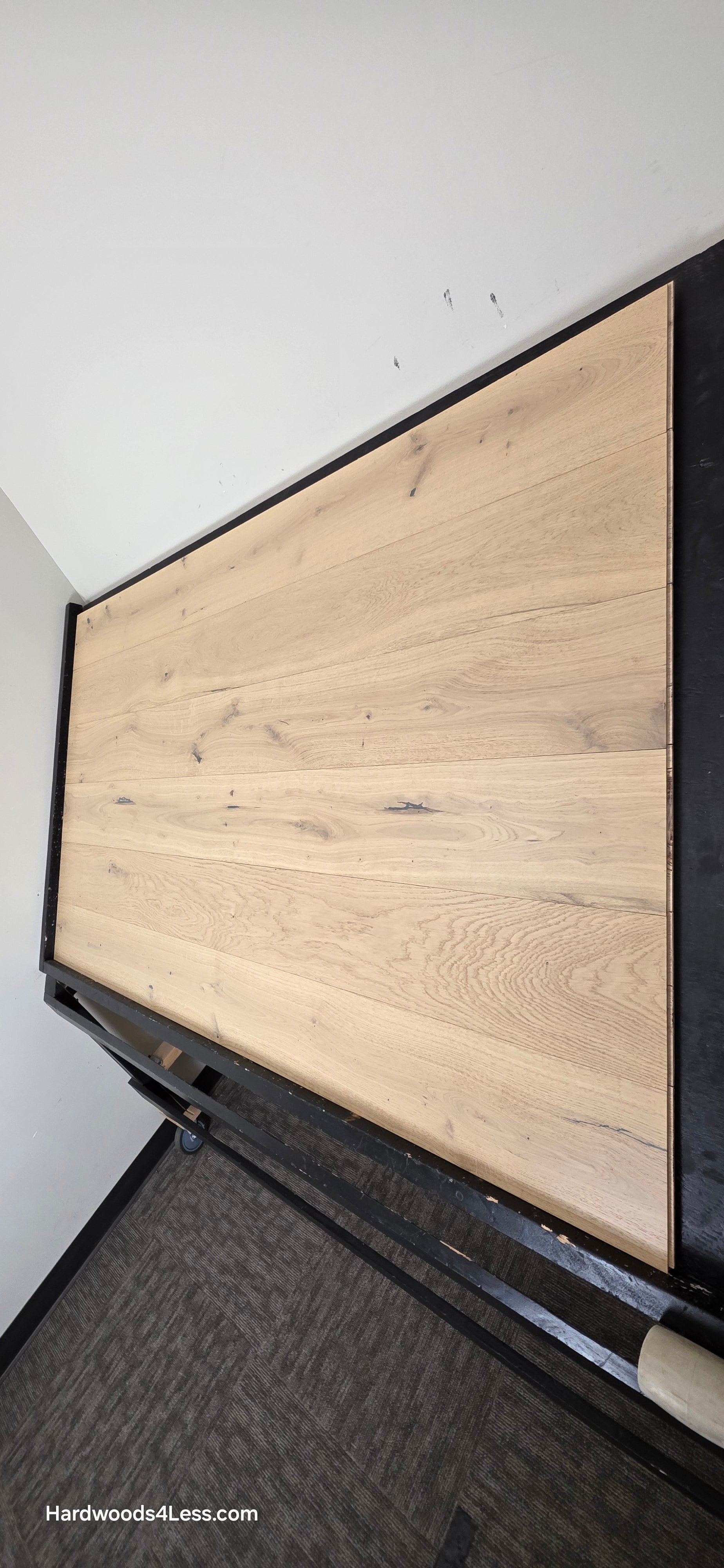 7 1/2" x 1/2" Engineered European White Oak Belleray Hardwood Flooring. Shown on a black shooting table. Shot from steep right.