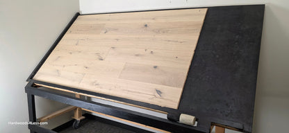 7 1/2" x 1/2" Engineered European White Oak Colmar Hardwood Flooring. Shown on a black shooting table. Shot from wide right.