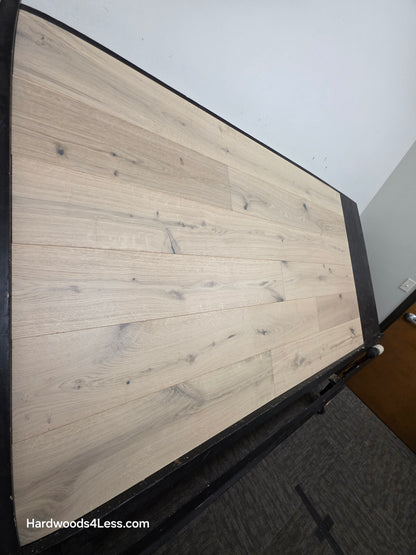 7 1/2" x 1/2" Engineered European White Oak Colmar Hardwood Flooring. Shown on a black shooting table. Shot from steep left. 