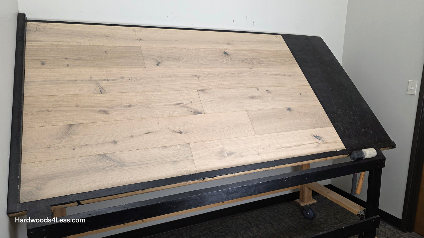 7 1/2" x 1/2" Engineered European White Oak Colmar Hardwood Flooring. Shown on a black shooting table. Shot from wide left.