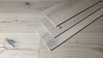 7 1/2" x 1/2" Engineered European White Oak Colmar Hardwood Flooring. Shown as 3 planks resting on top of each other. These are sitting center frame on top of the Engineered White Oak flooring.