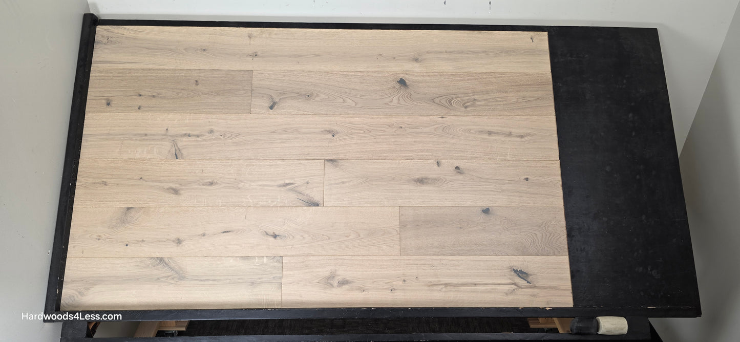 7 1/2" x 1/2" Engineered European White Oak Colmar Hardwood Flooring. Shown on a black shooting table. Shot from center.