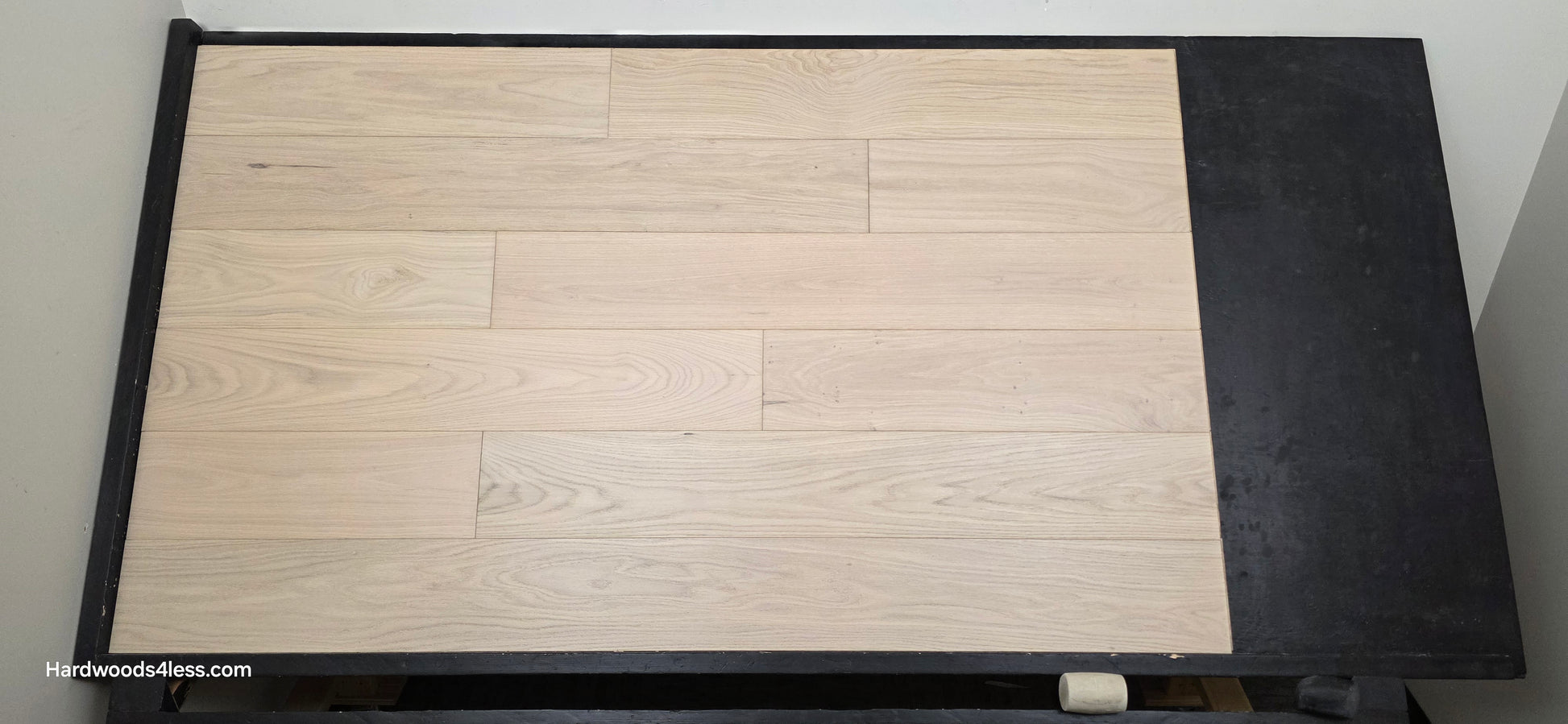 7 1/2" x 1/2" Engineered European White Oak Florence Hardwood Flooring. Shown on a black shooting table. Shot from center.