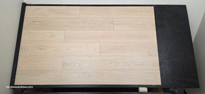 7 1/2" x 1/2" Engineered European White Oak Florence Hardwood Flooring. Shown on a black shooting table. Shot from center.