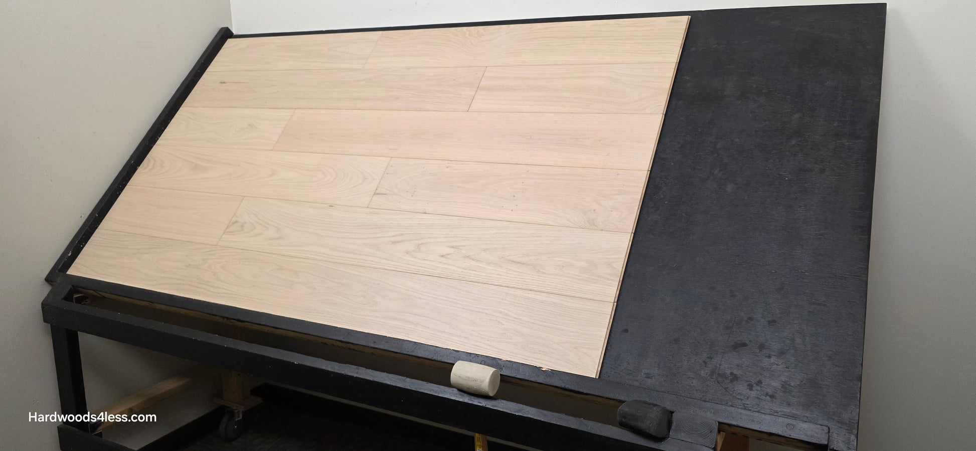 7 1/2" x 1/2" Engineered European White Oak Florence Hardwood Flooring. Shown on a black shooting table. Shot from wide right.