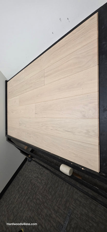 7 1/2" x 1/2" Engineered European White Oak Florence Hardwood Flooring. Shown on a black shooting table. Shot from steep right.