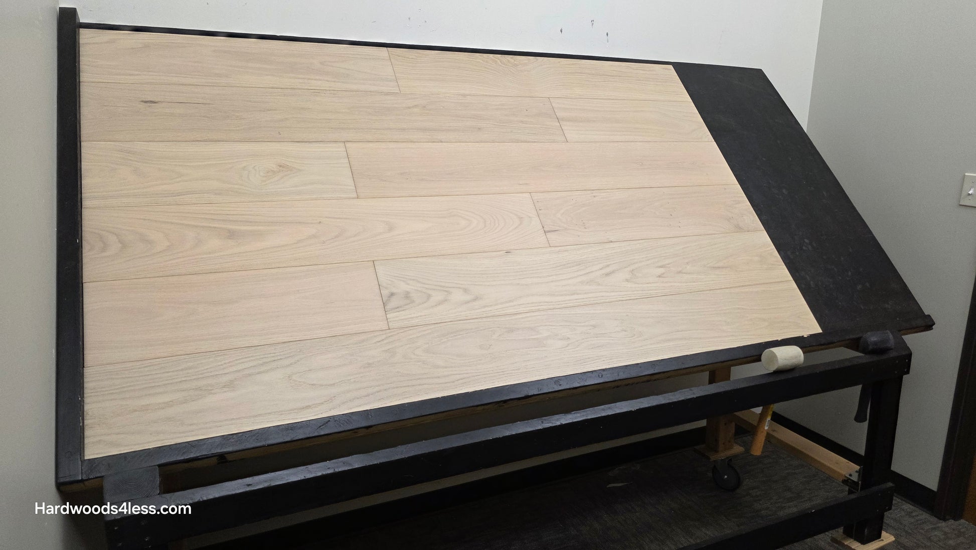 7 1/2" x 1/2" Engineered European White Oak Florence Hardwood Flooring. Shown on a black shooting table. Shot from wide left. 