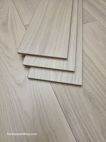 7 1/2" x 1/2" Engineered European White Oak Florence Hardwood Flooring. Shown as three tiles stacked atop the flooring.