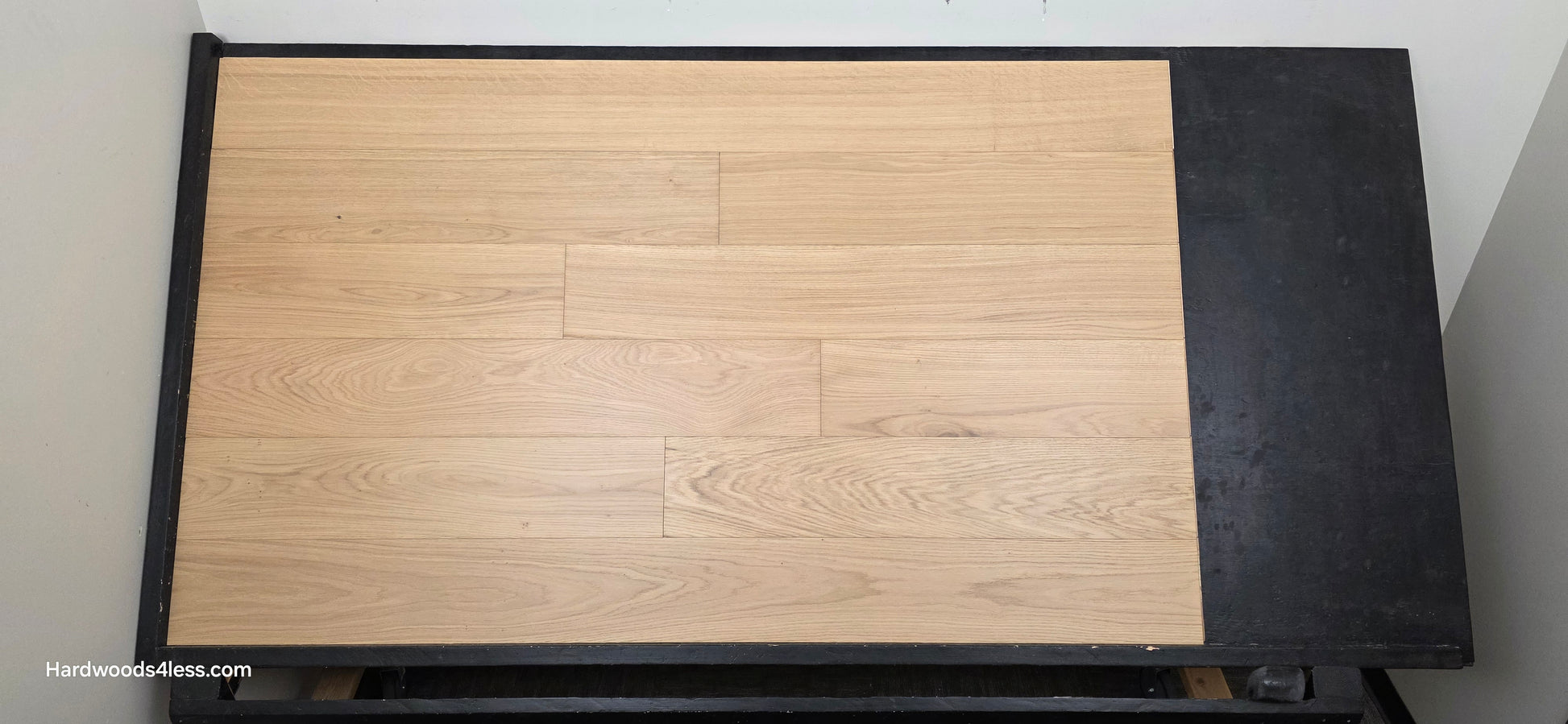 7 1/2" x 1/2" Engineered European White Oak Venice Hardwood Flooring. Shown on a black shooting table. Shot from steep left. 