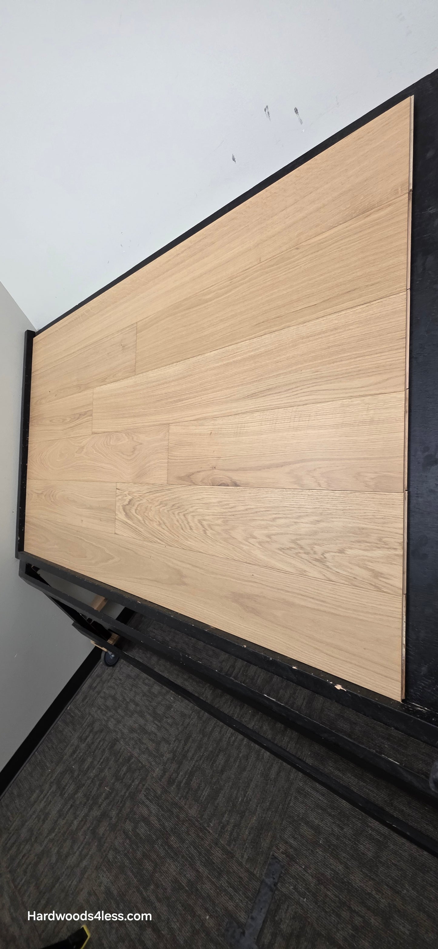 7 1/2" x 1/2" Engineered European White Oak Venice Hardwood Flooring. Shown on a black shooting table. Shot from steep right.