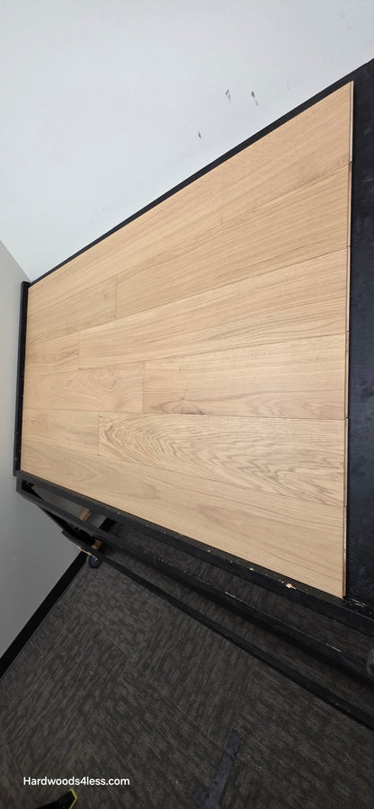 7 1/2" x 1/2" Engineered European White Oak Venice Hardwood Flooring. Shown on a black shooting table. Shot from steep right.