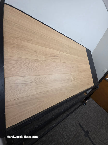 7 1/2" x 1/2" Engineered European White Oak Venice Hardwood Flooring. Shown on a black shooting table. Shot from steep left. 