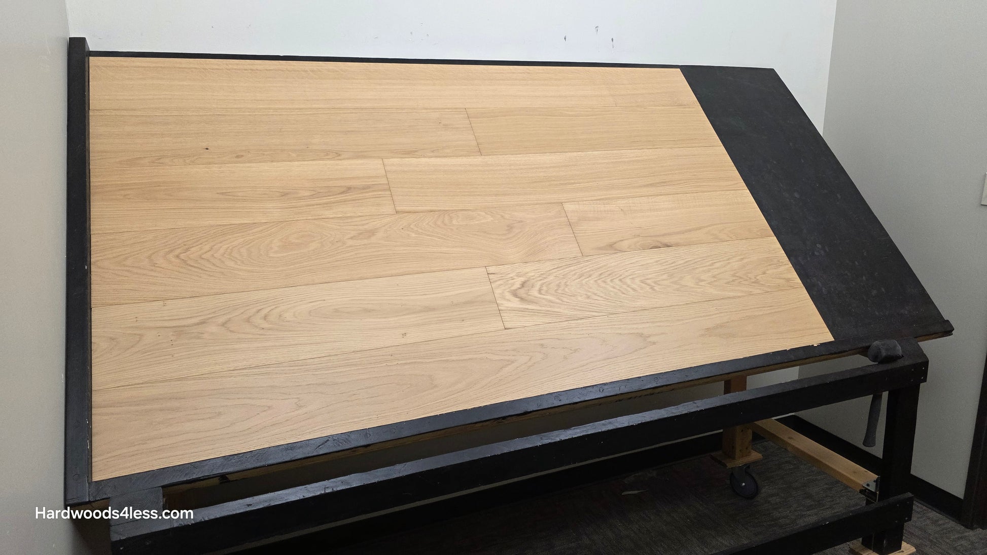 7 1/2" x 1/2" Engineered European White Oak Venice Hardwood Flooring. Shown on a black shooting table. Shot from wide left. 