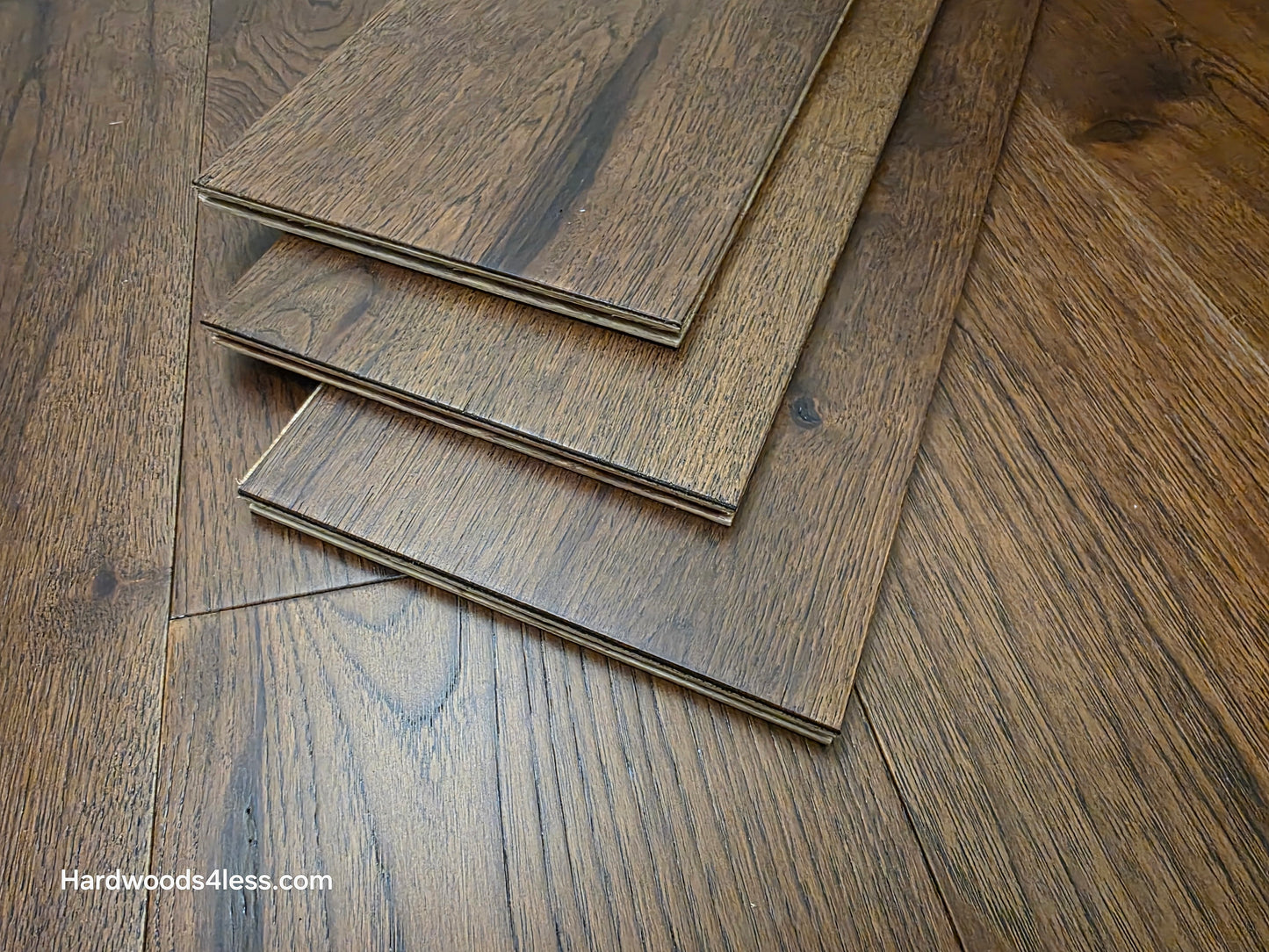 7 1/2" x 1/2" Engineered Hickory Mauna Kea Hardwood Flooring. Shown as three boards stacked atop the floor. 