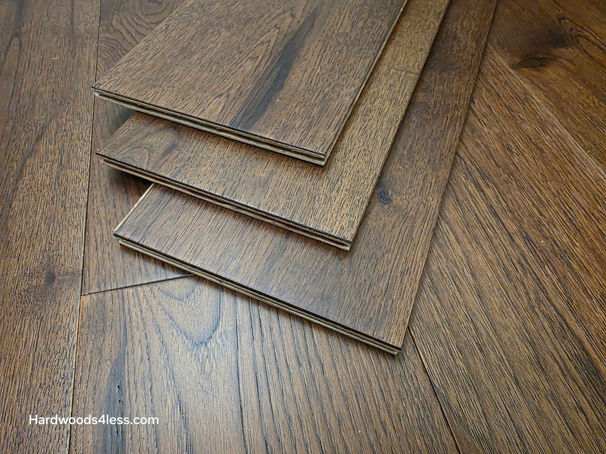 7 1/2" x 1/2" Engineered Hickory Mauna Kea Hardwood Flooring. Shown as three boards stacked atop the floor. 