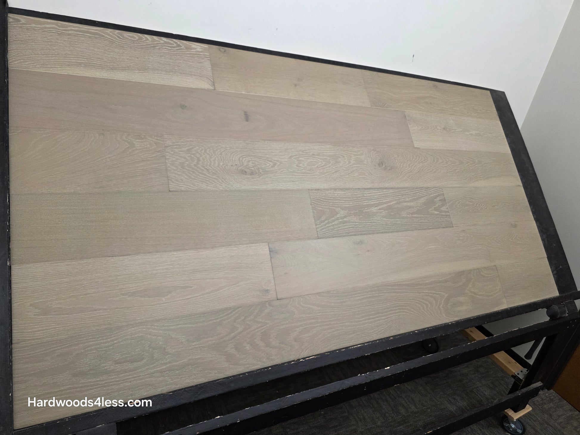 7 1/2" x 9/16" Engineered European Oak Alderney Hardwood Flooring shown on a black shooting table. Left hand side.