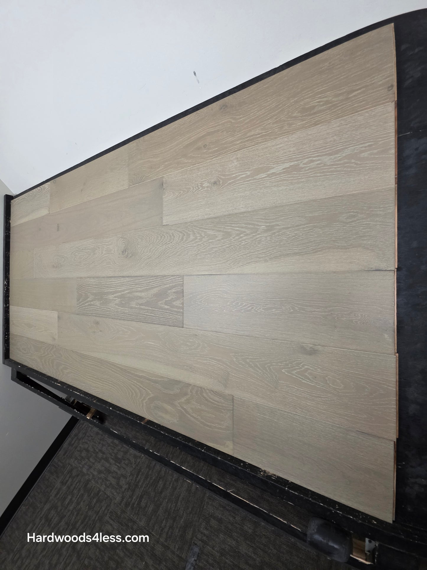7 1/2" x 9/16" Engineered European Oak Alderney Hardwood Flooring shown on a black shooting table from the right hand side.