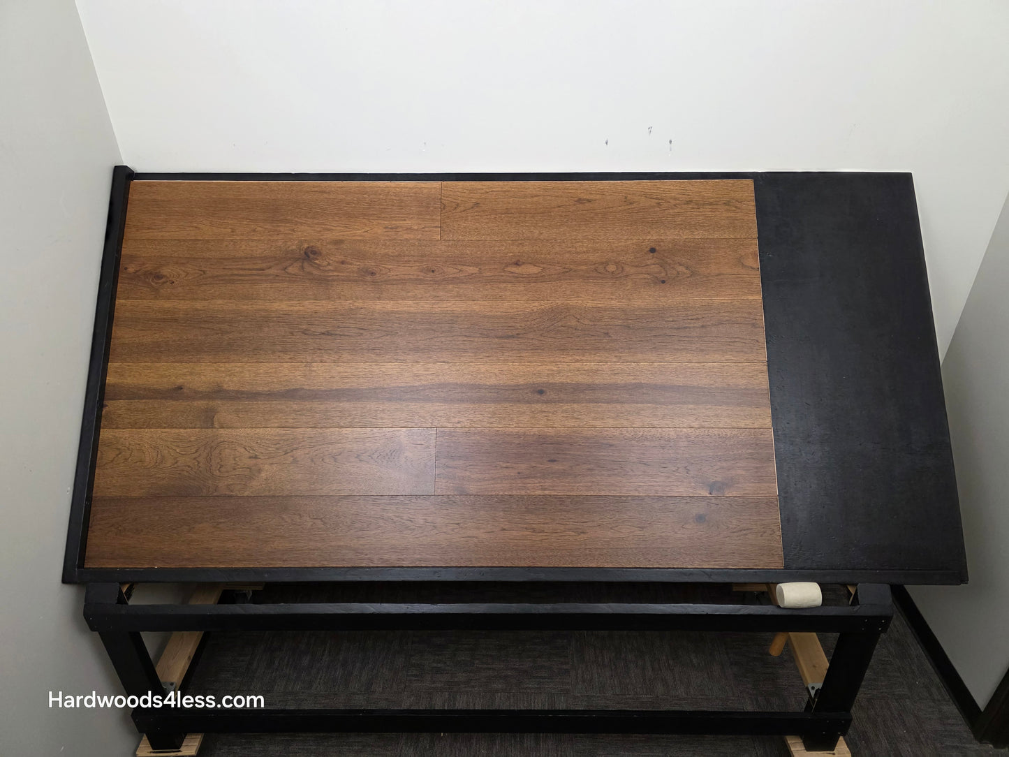 7 1/2" x 9/16" Engineered Hickory Alabay Hardwood Flooring with a visible brand name 'Hardwoods4less.com'.
Shown on a black shooting table. Shot from center.