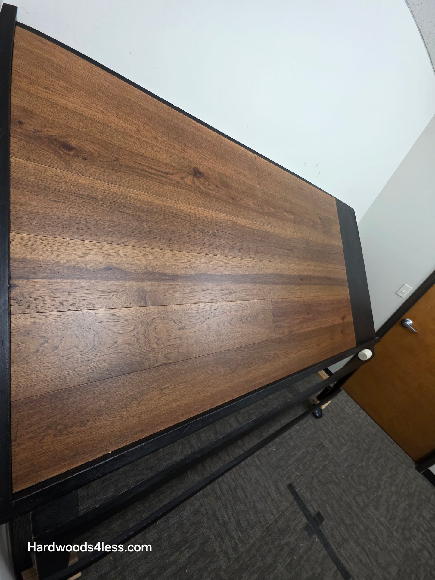 7 1/2" x 9/16" Engineered Hickory Alabay Hardwood Flooring with a visible brand name 'Hardwoods4less.com'.
Shown on a black shooting table. Shot from steep left.