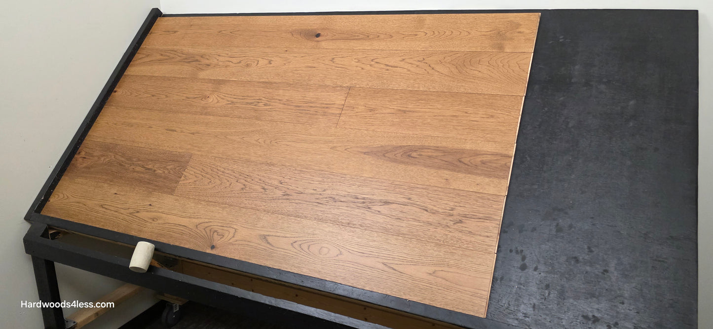 7 1/2" x 9/16" Engineered Hickory English Toffee Hardwood Flooring. Shown on a black shooting table. Shot wide right. 