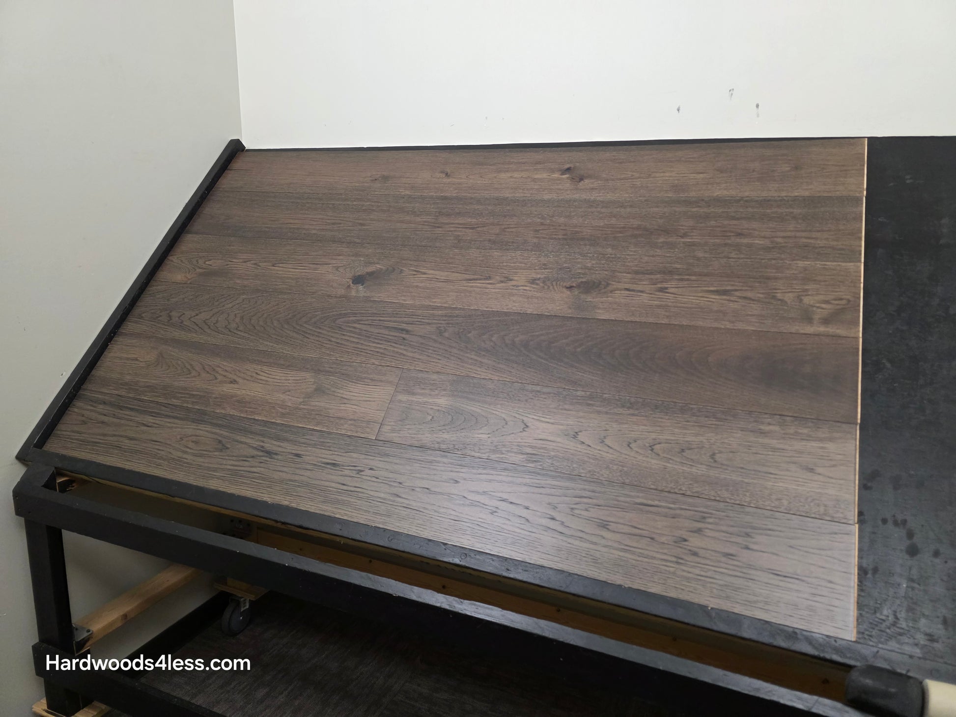  7 1/2" x 9/16" Engineered Hickory Quarry Hardwood Flooring. Shown on a black shooting table. Shot from wide right.